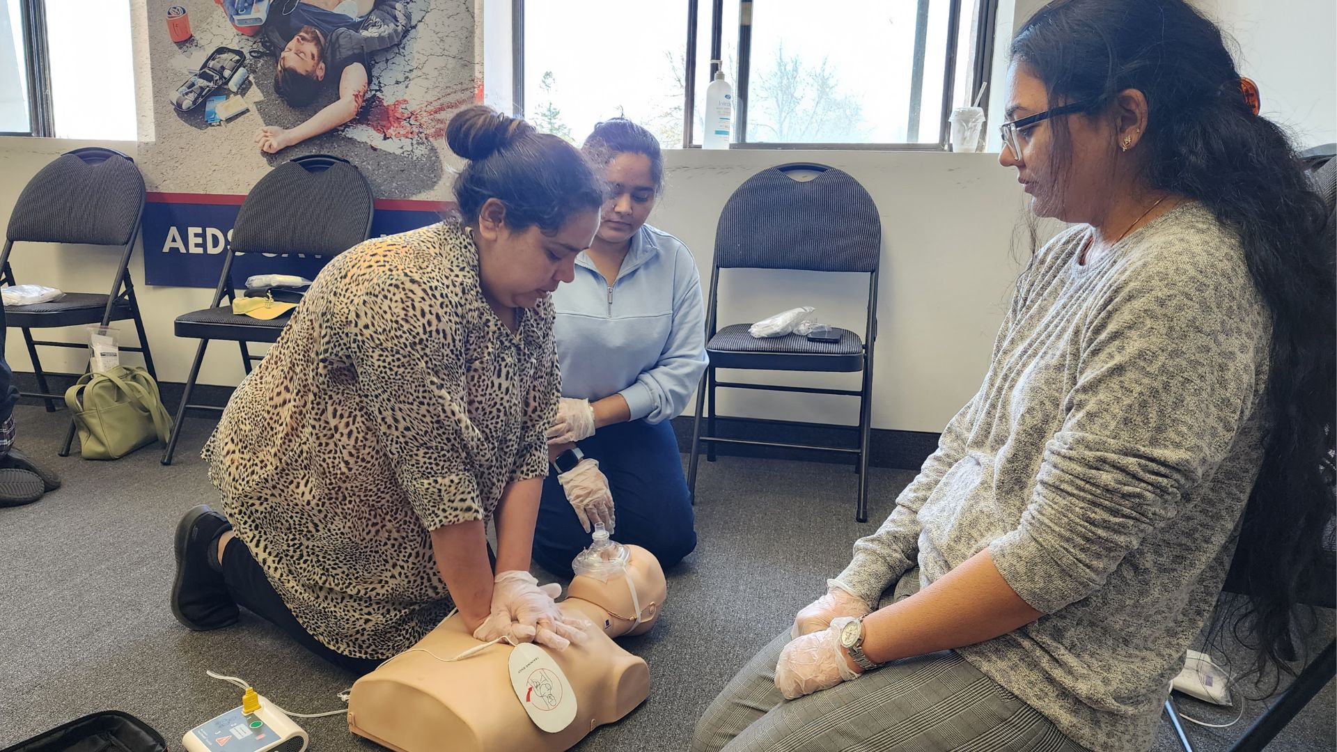 First Aid student practicing CPR on a mannequin