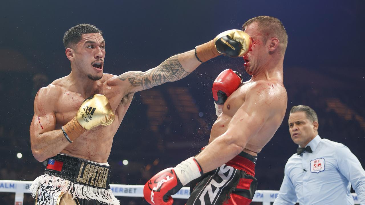 a boxer suffering from nosebleed after a punch to the face.