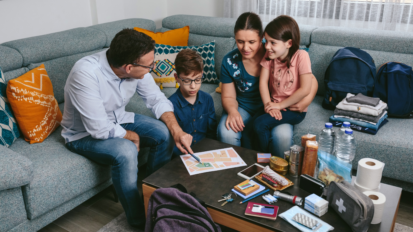 A mother and father educating and showing their children first aid supplies.