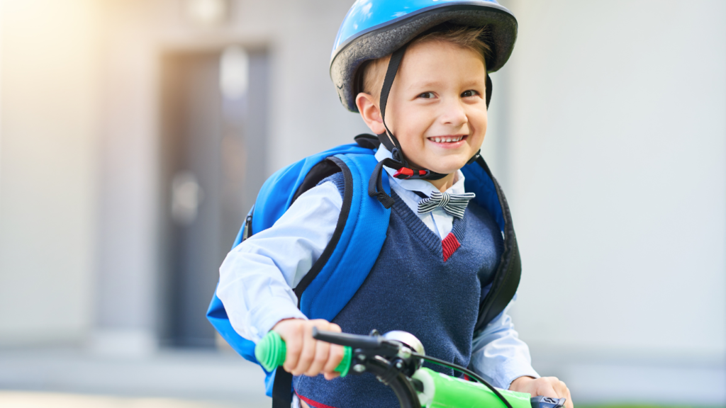 A child wearing a helmet and riding a bike