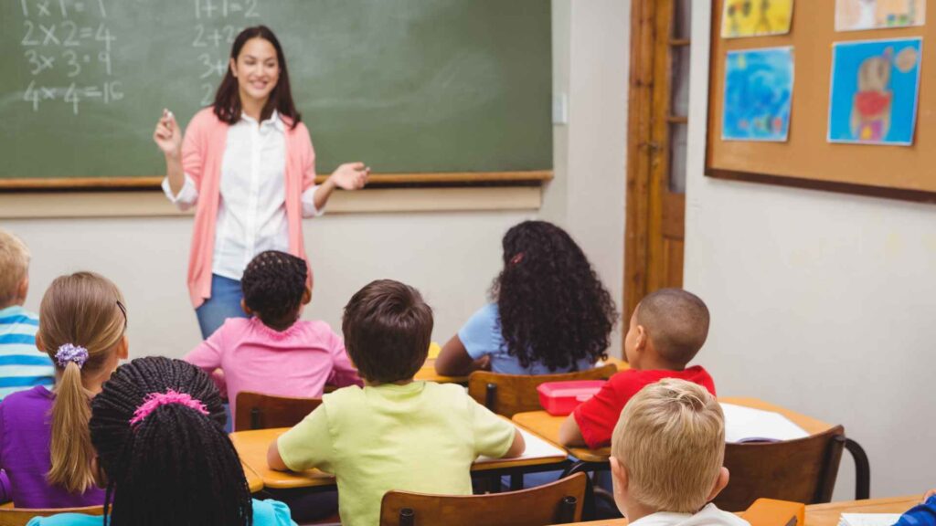 Teacher explaining things to children