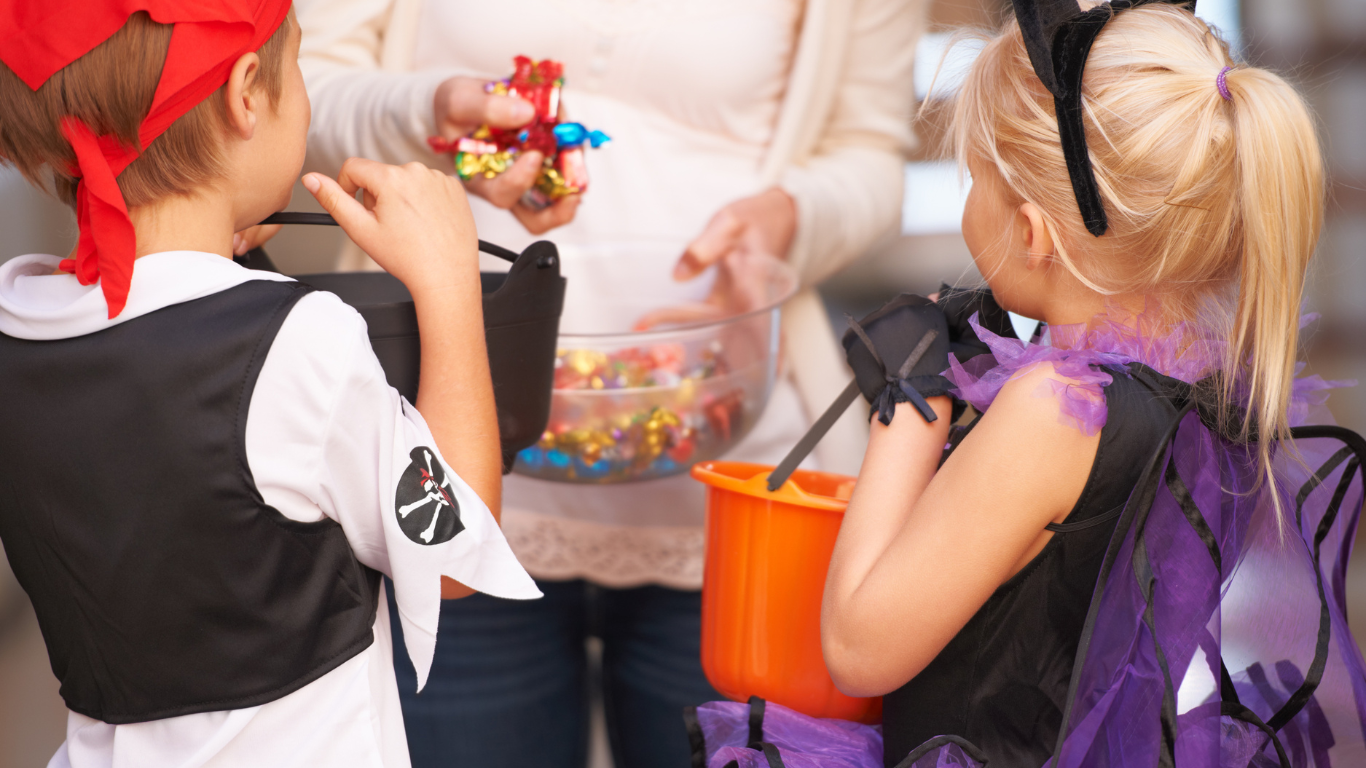 Two kids in their Halloween costumes Trick or Treating