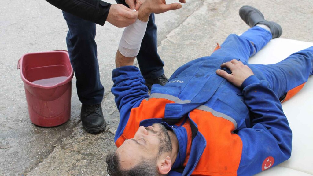 First Aider assisting a victim with a bandage.