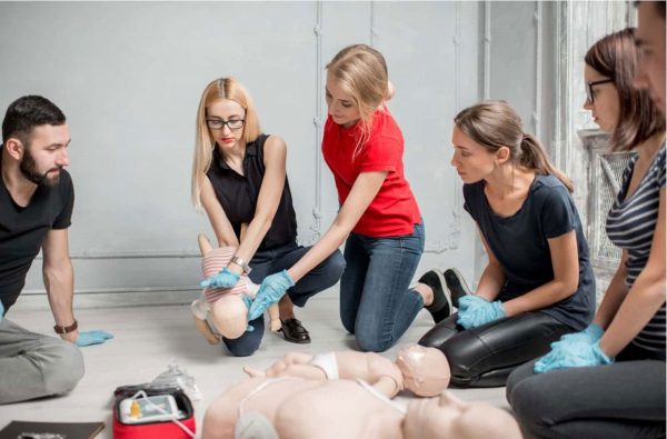 Instructor and students in a first aid training