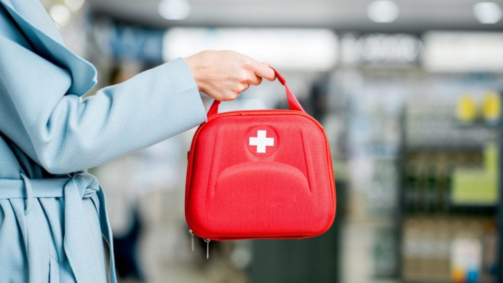 Person holding a first aid kit.