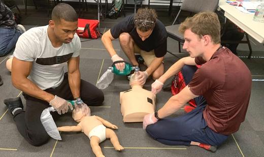 students practicing using bvm on a mannequin for cpr at the etobicoke location