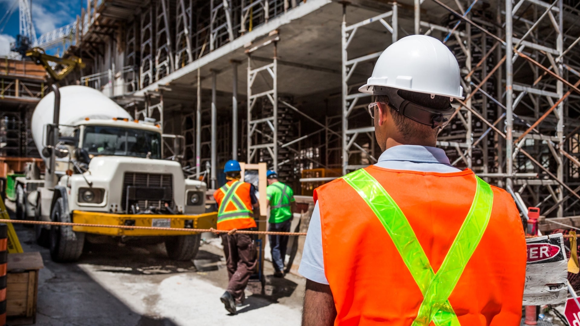 construction supervisor checking on workers