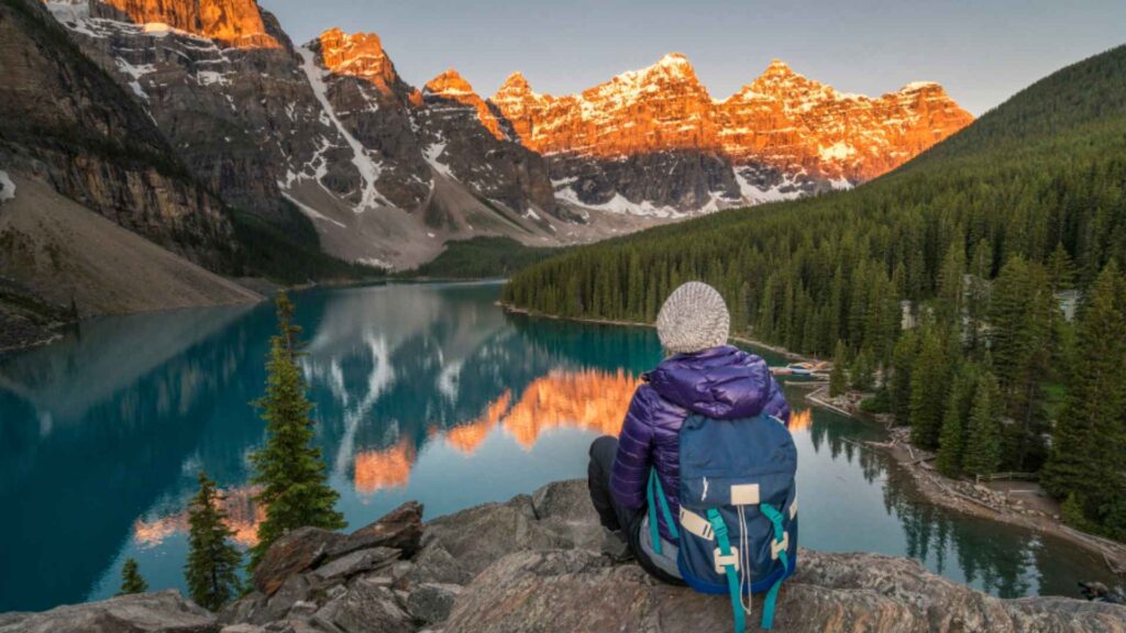 Hiker appreciating the mountains and a lake in Alberta