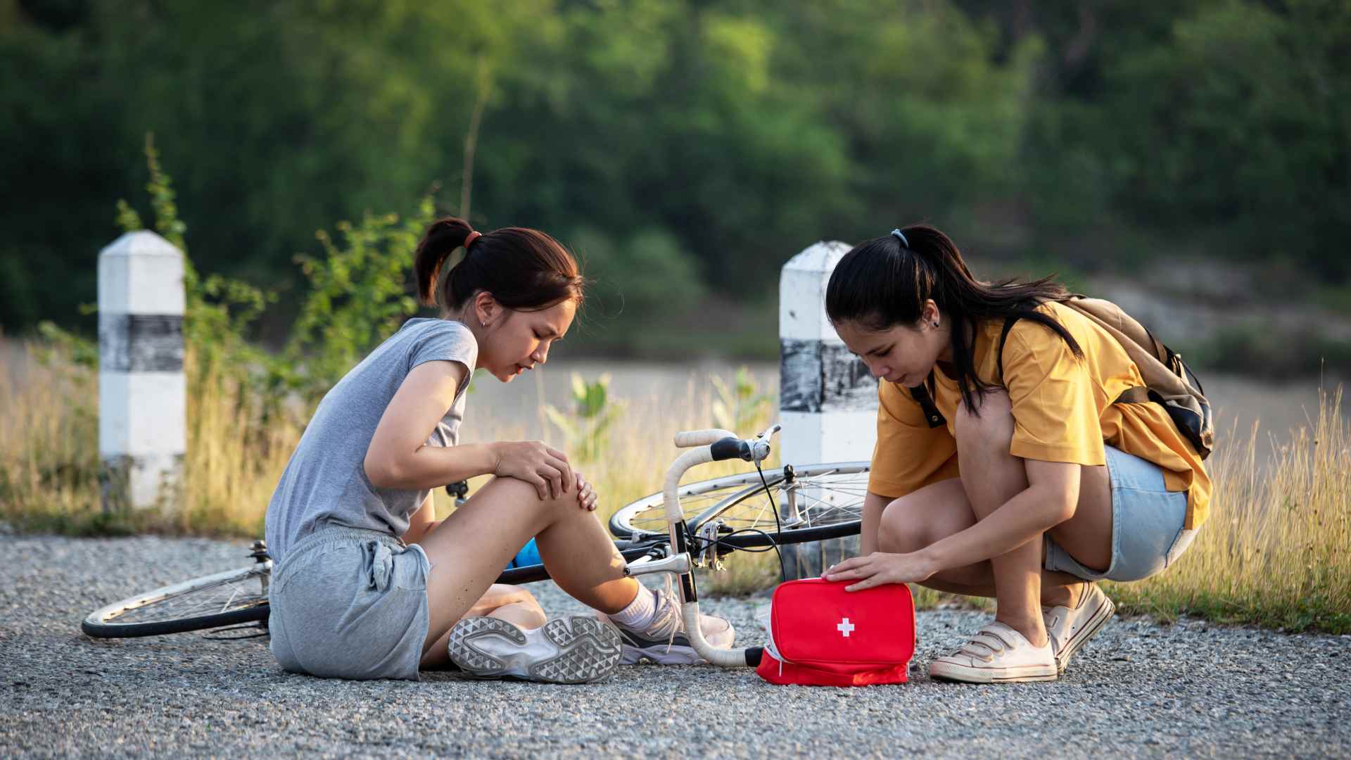 a girl doing first aid on her friend during a vacation