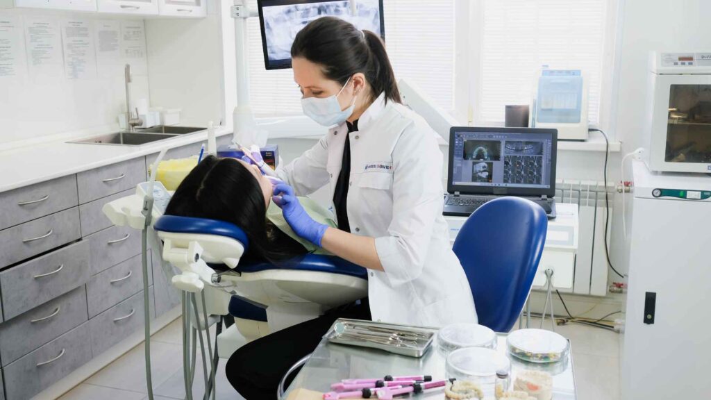 A dentist treating her patient in a clinic.