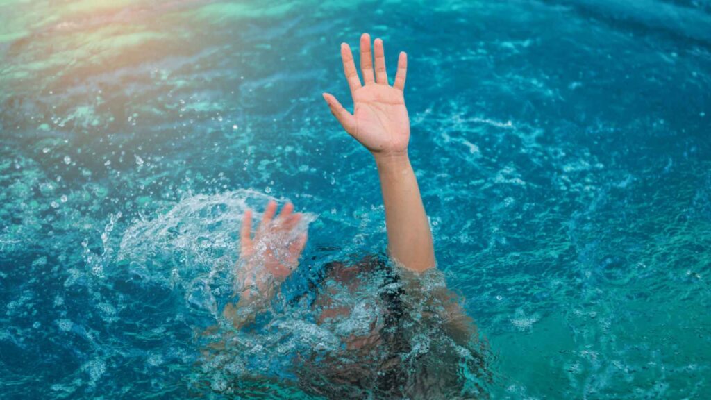 a person drowning in a swimming pool.