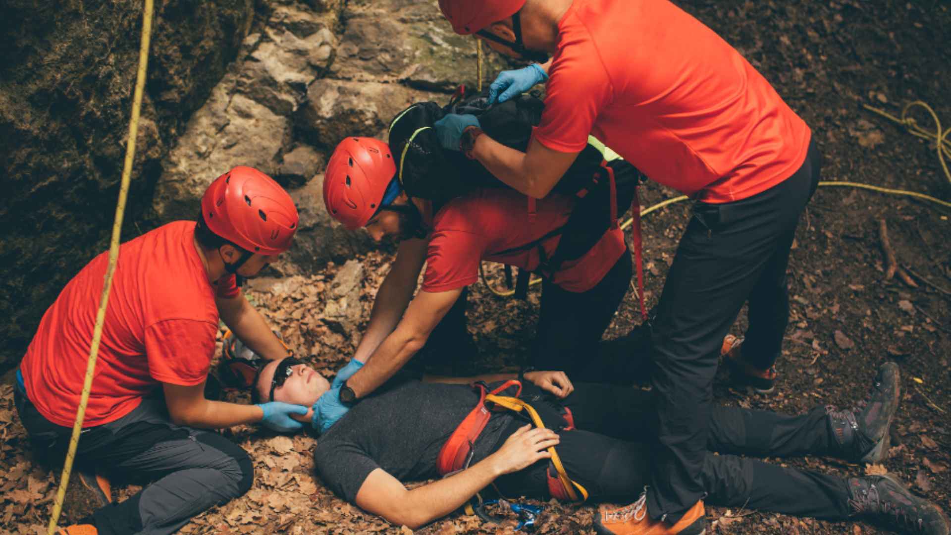 A group of hikers providing remote first aid to a fellow injured hiker