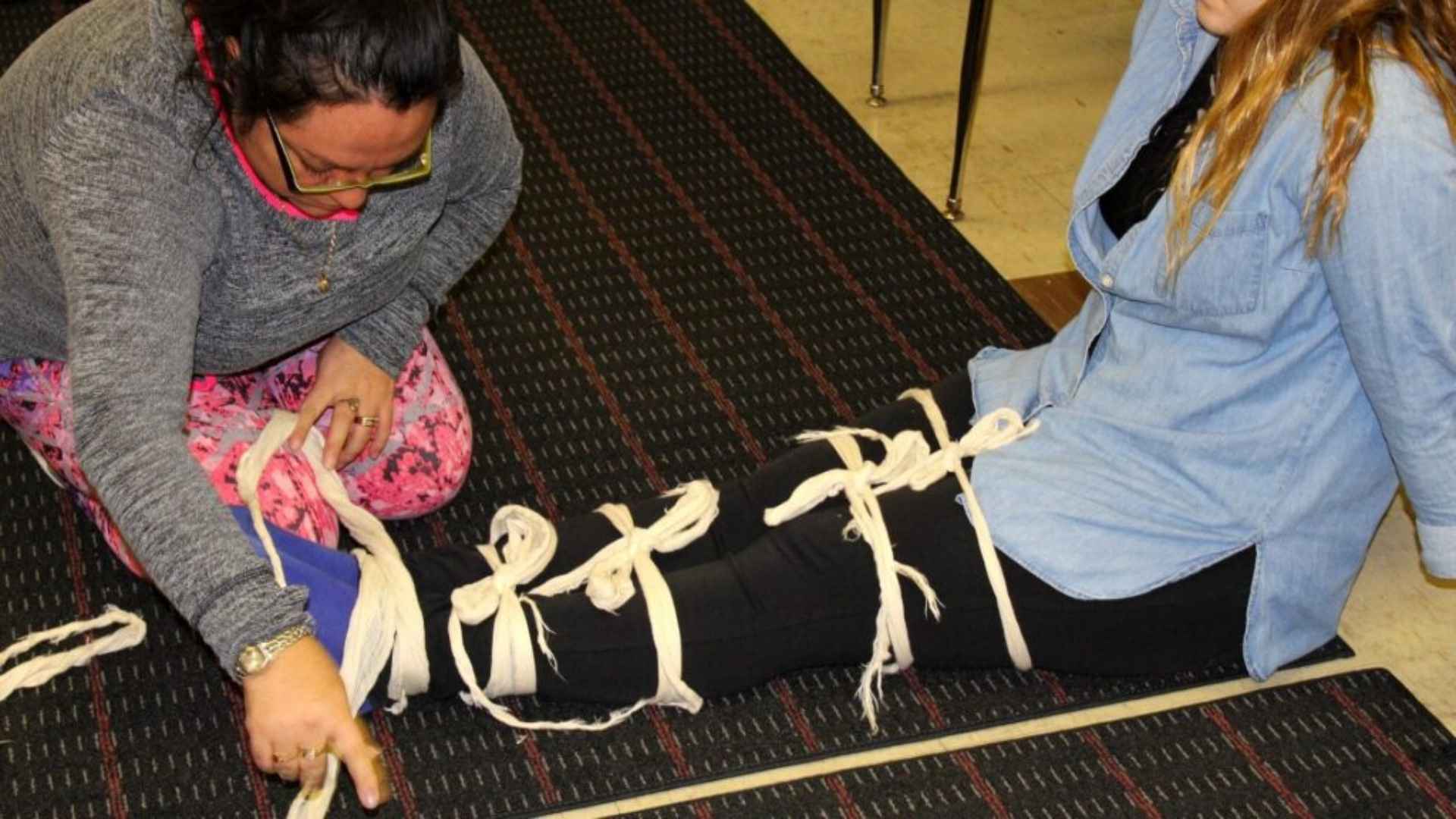 Two people practicing first aid techniques in a course