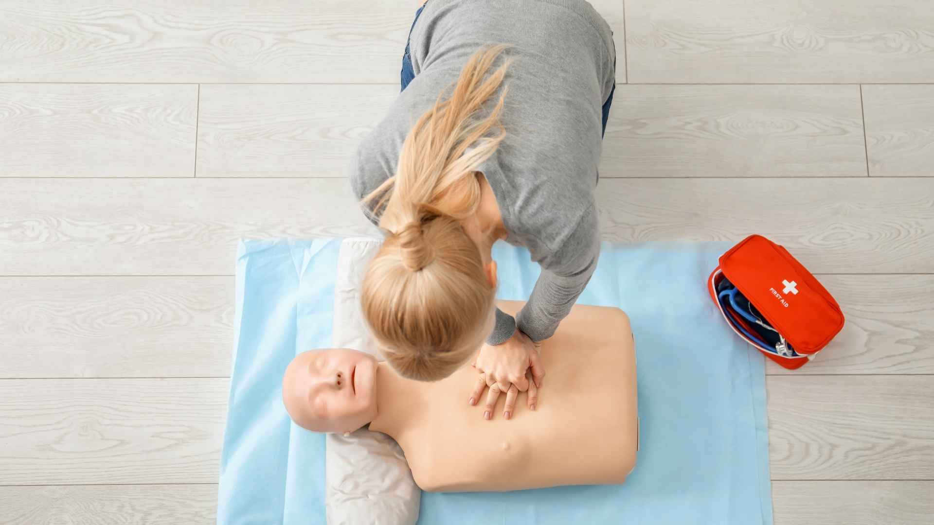 A first aid professional teaching CPR.