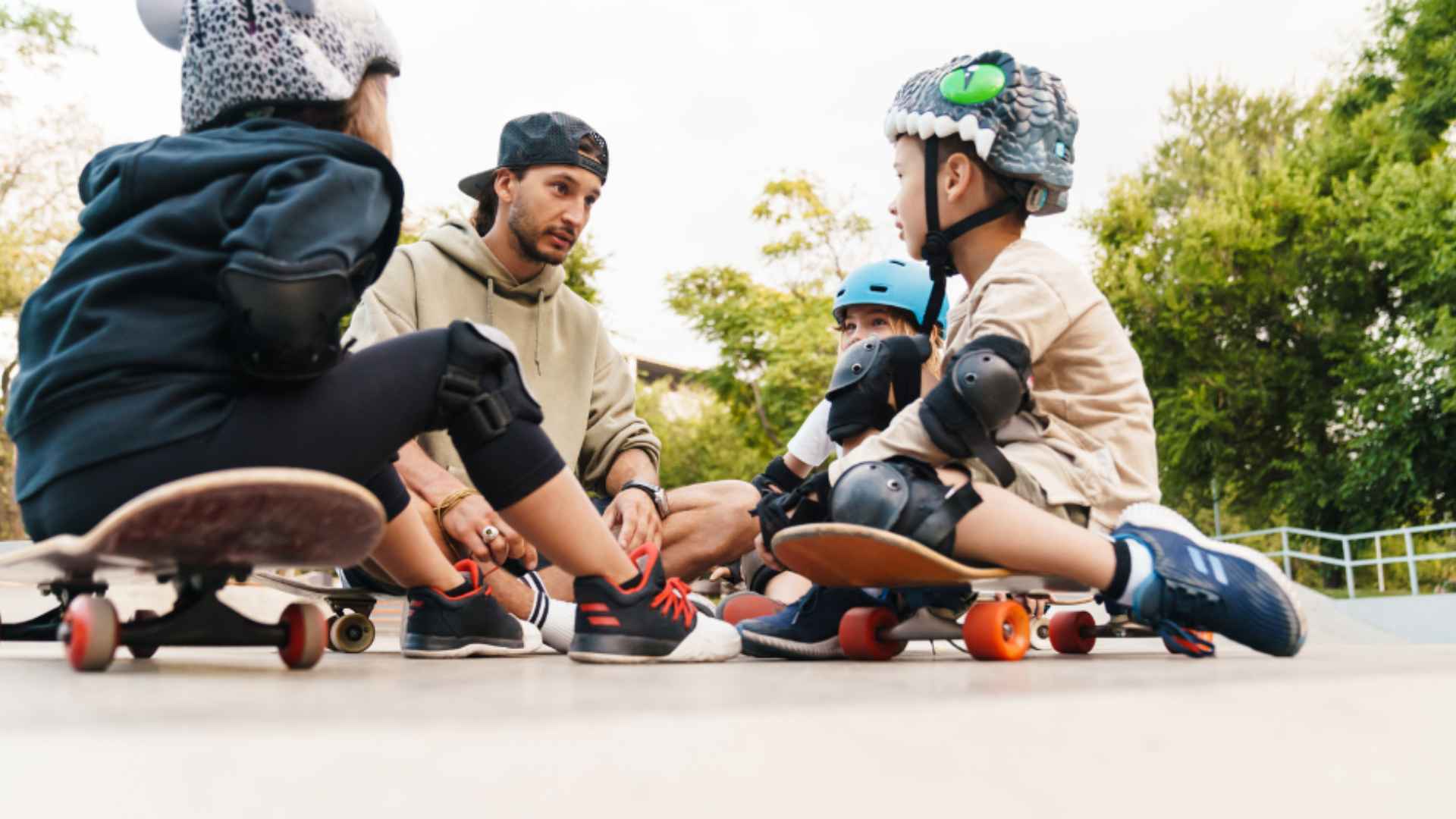 A parent teaching his children to wear safety gear to avoid accidents.