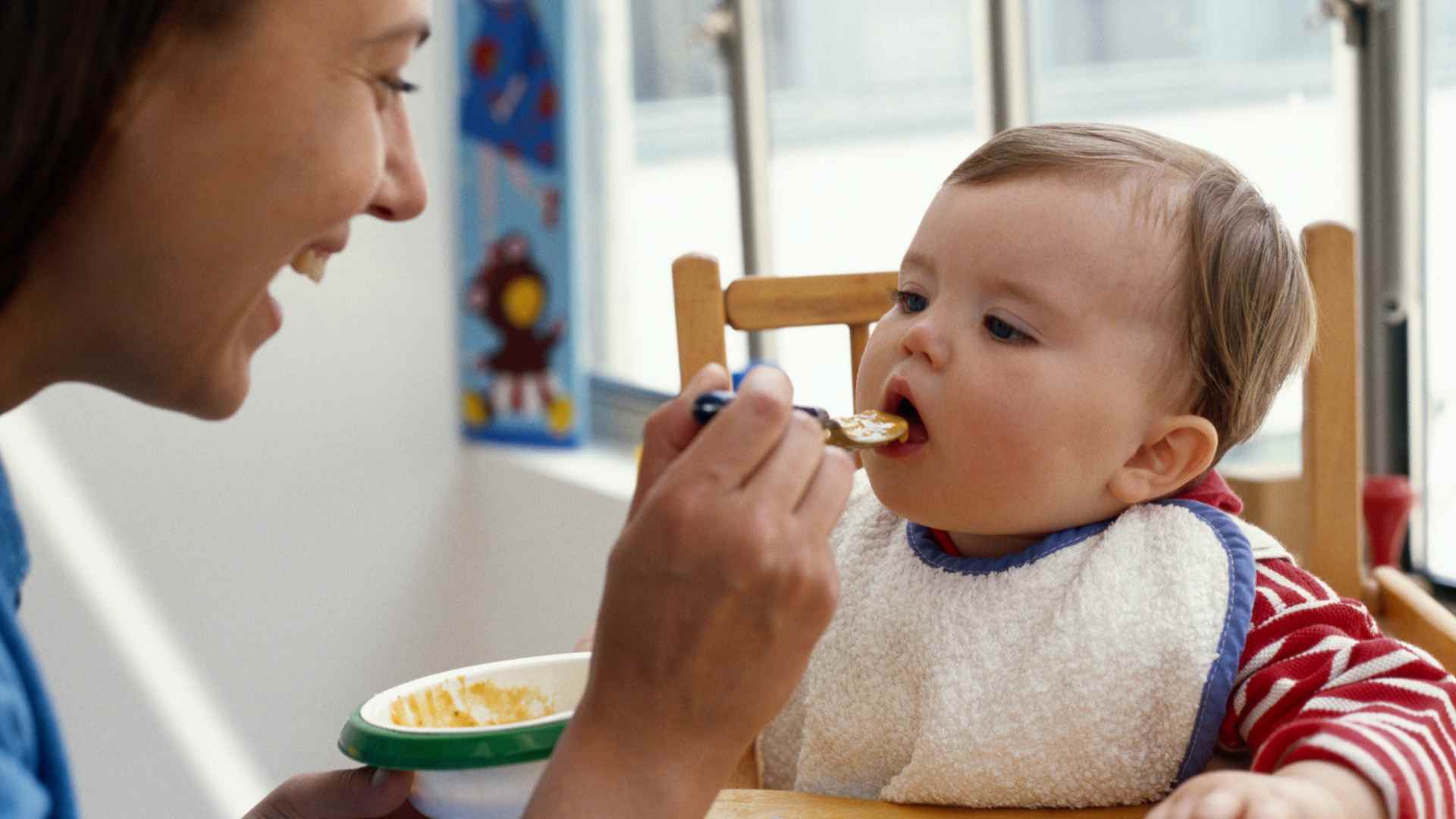 A mother feeding her child.