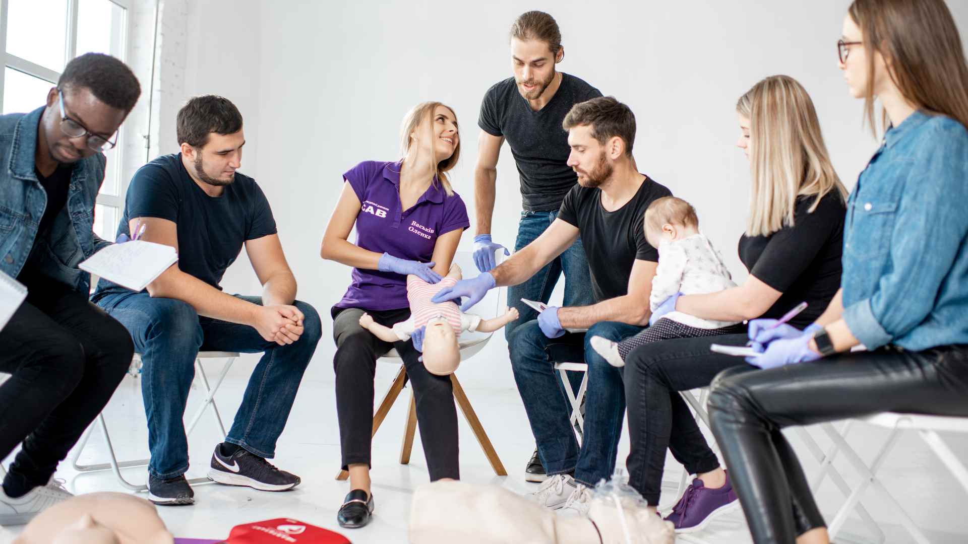 A group of parents learning first aid skills at Coast2Coast.