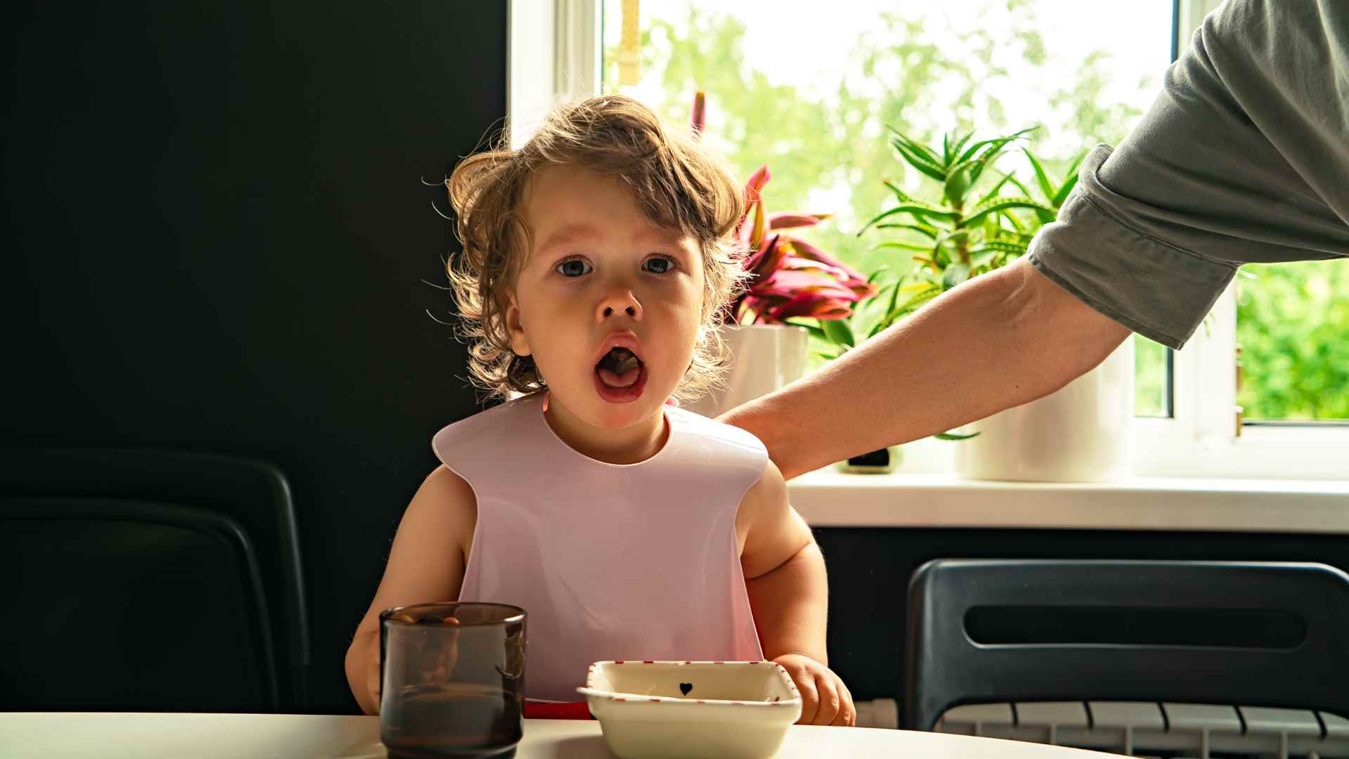 A small baby choking in need of immediate first aid skills.