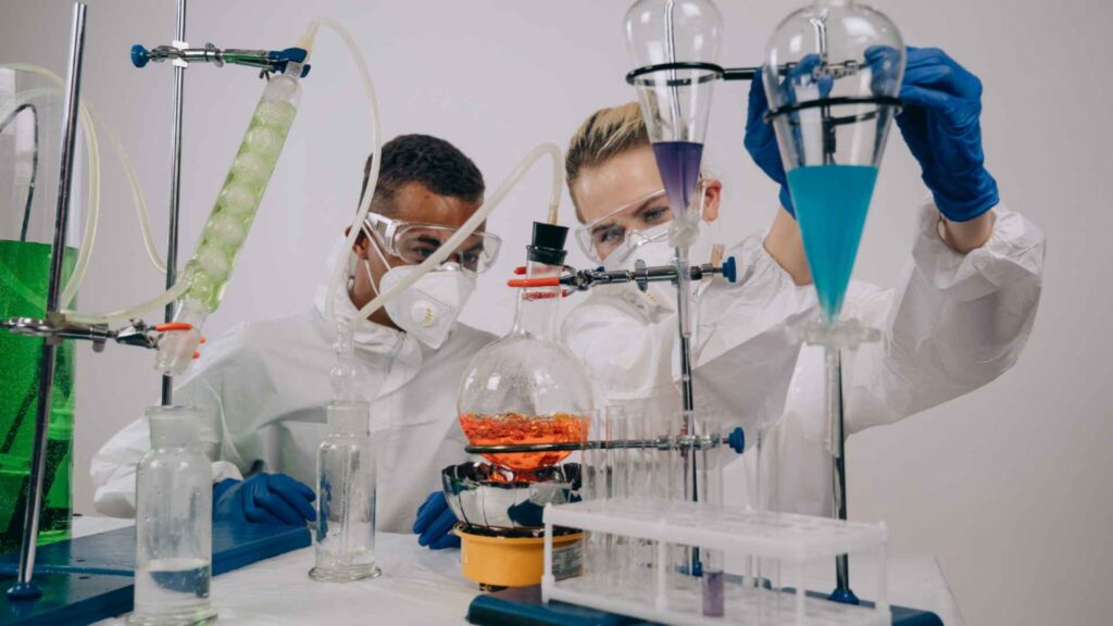 Scientists demonstrating proper safety equipment in a laboratory setting