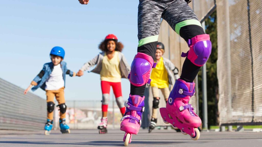 Children roller skating with protective gear